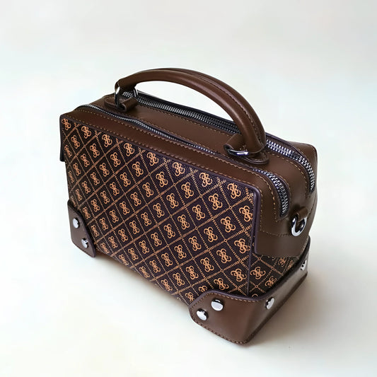 Brown handbag with patterned front section on a white background
