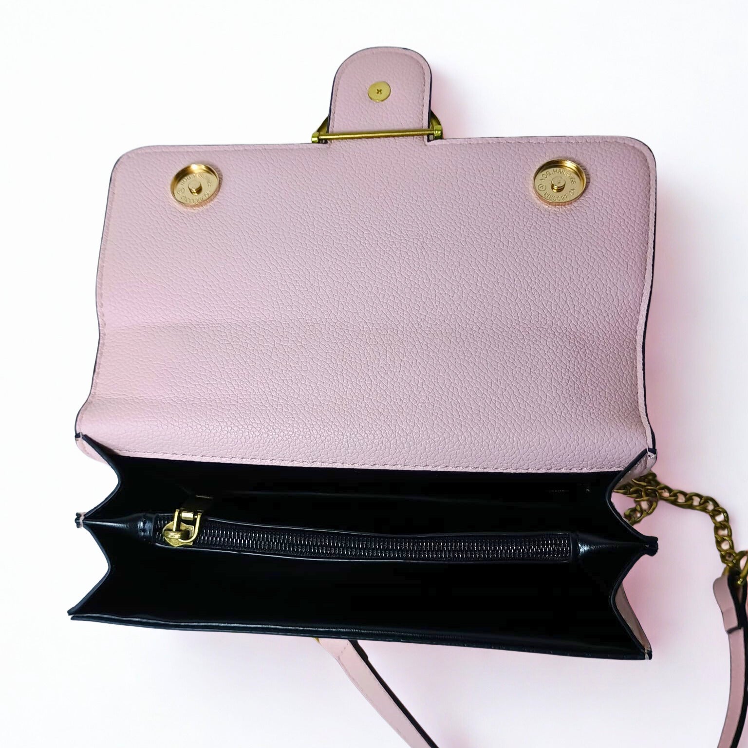 Pink handbag with gold accents on a white background