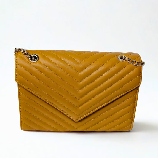 Yellow quilted handbag with gold chain on a white background