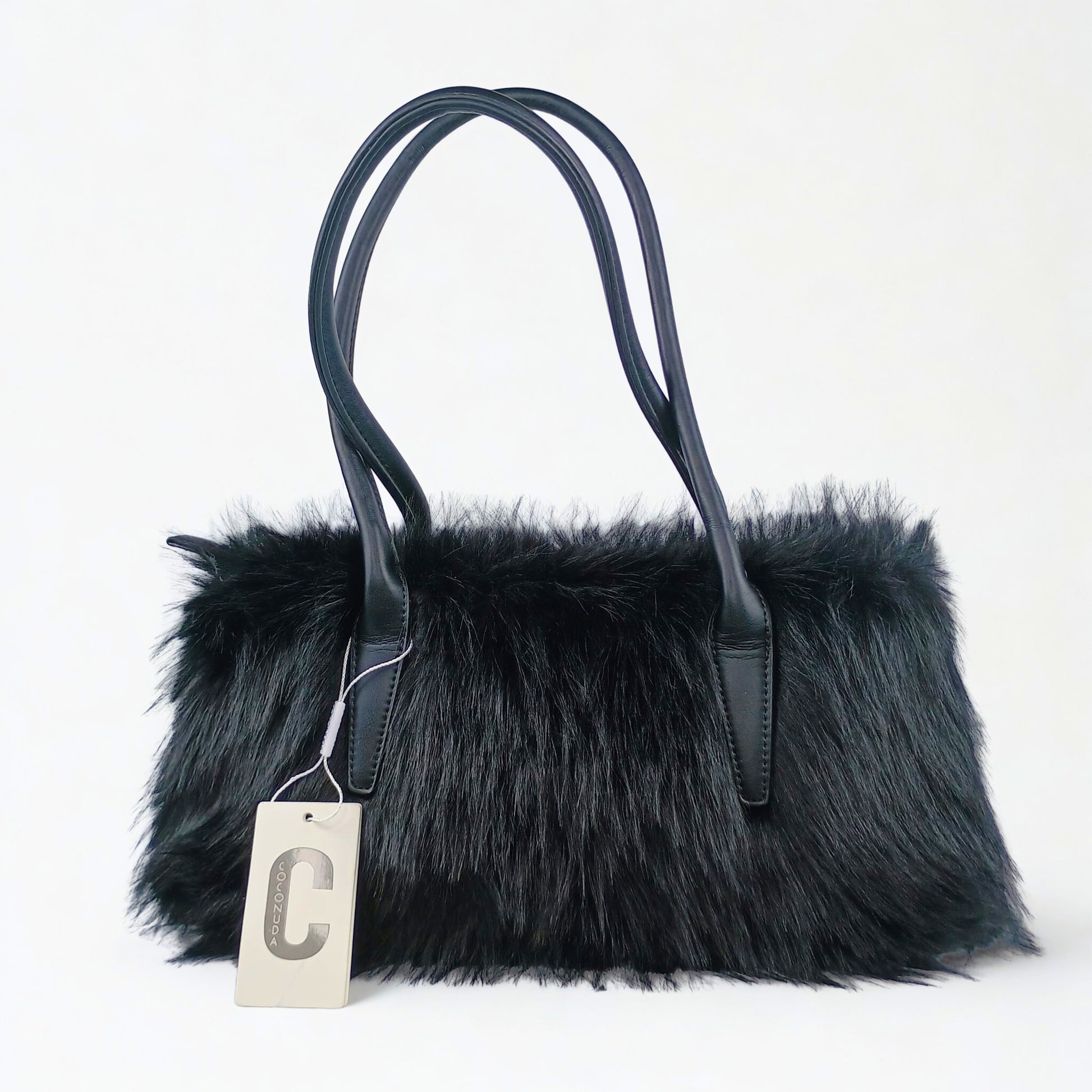Black fur handbag with a visible brand tag on a white background