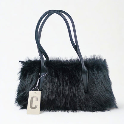 Black fur handbag with a visible brand tag on a white background