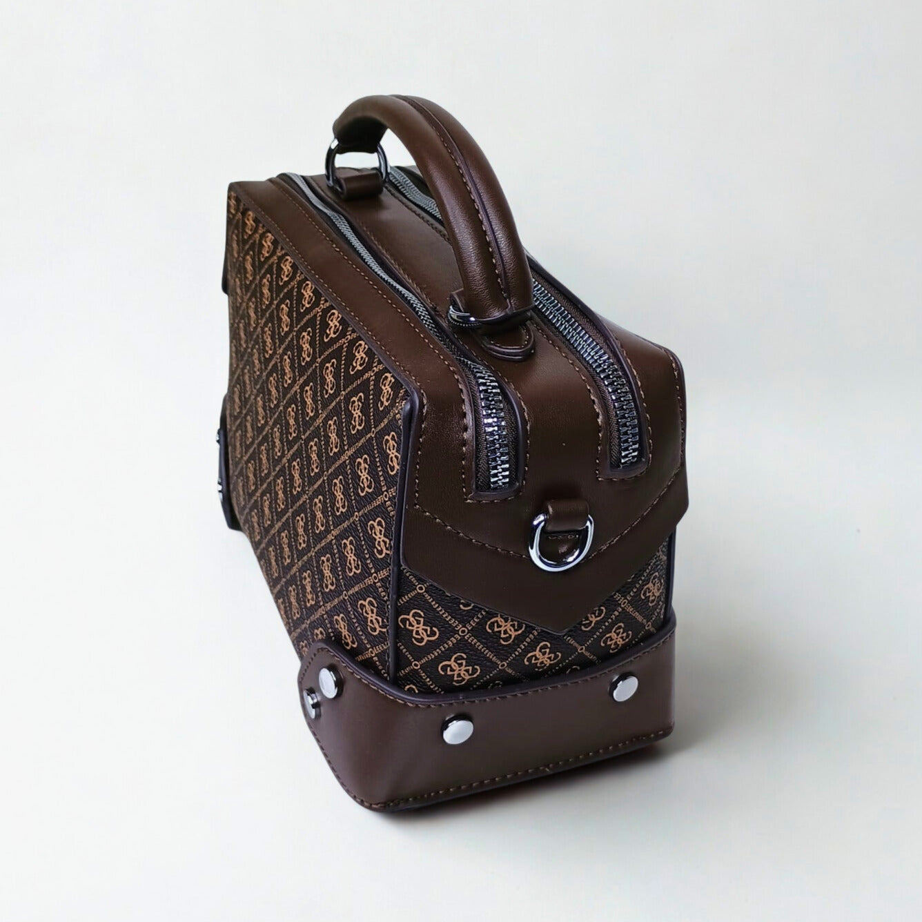 Brown leather handbag with a pattern on a white background