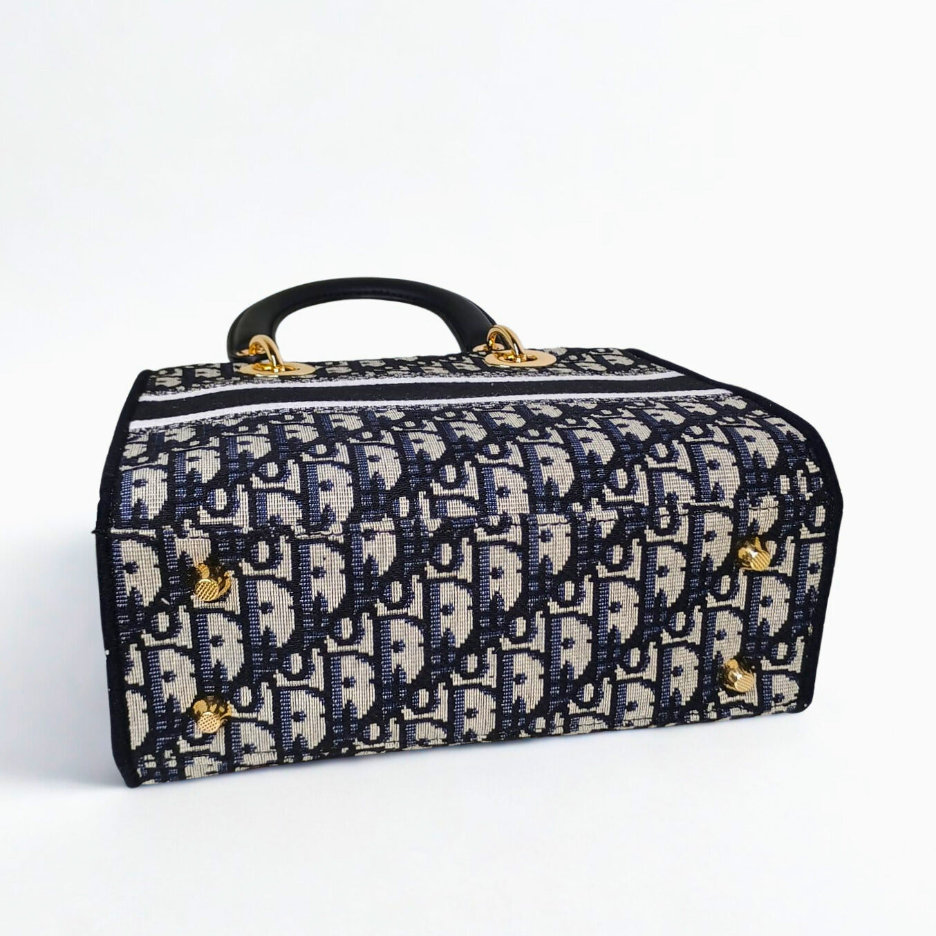 Patterned suitcase with gold accents on a white background