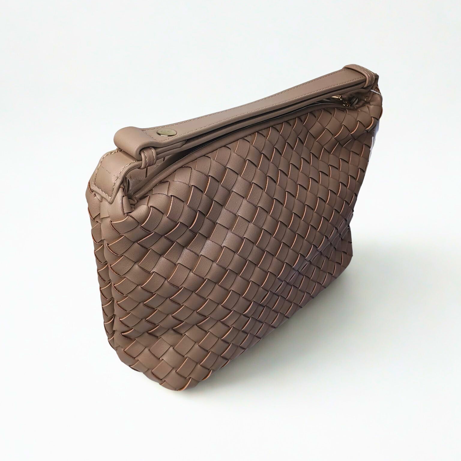 Brown woven handbag on a white background