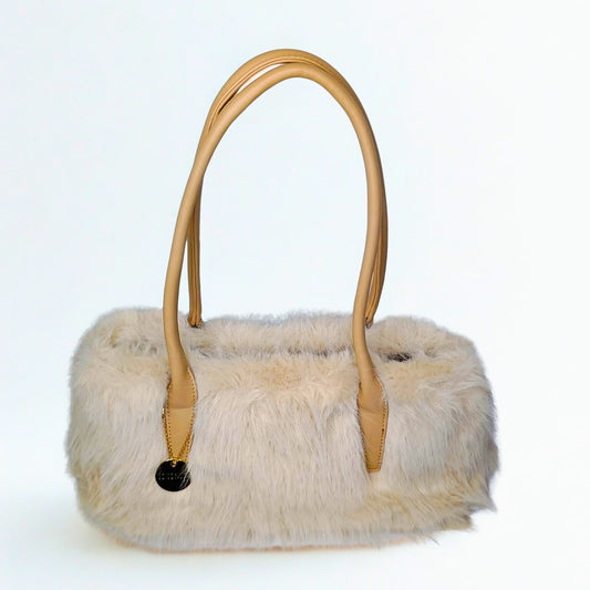 Cream-colored Cocunuda Fur Leather Handbag with tan leather handles and gold charm