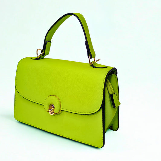 Green handbag with gold accents on a light blue background