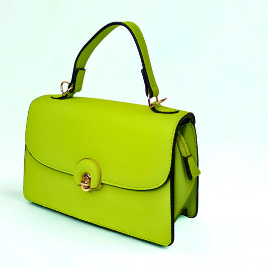 Green handbag with gold accents on a light blue background