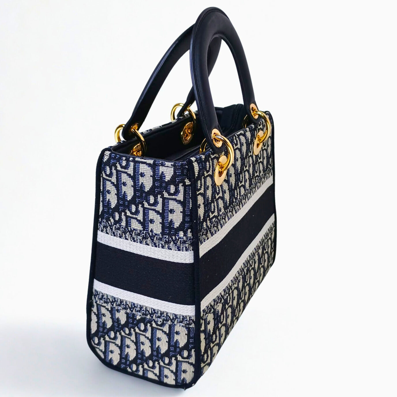 Designer handbag with black, white, and blue pattern on a white background