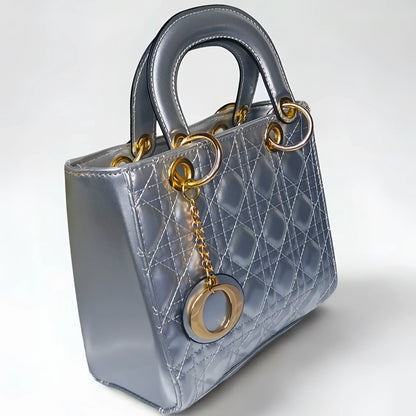 Silver handbag with gold accents on a white background