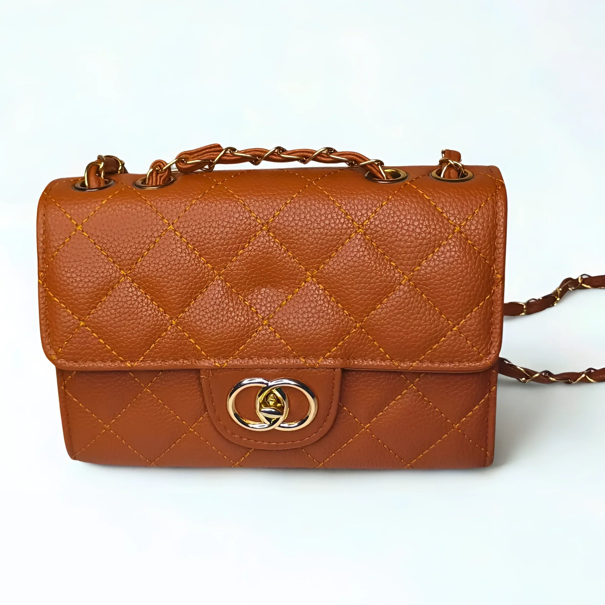 Brown quilted handbag with gold accents on a white background