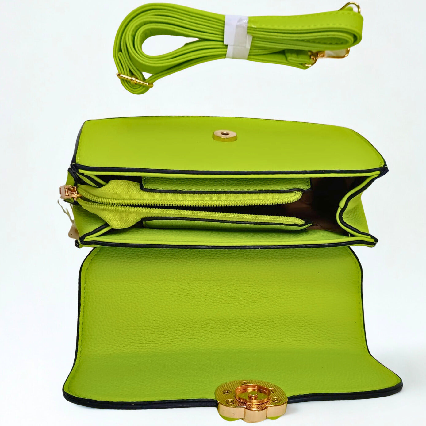 Green handbag with a strap and clasp on a white background