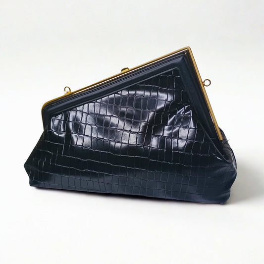 Black crocodile-patterned handbag with gold frame on a white background