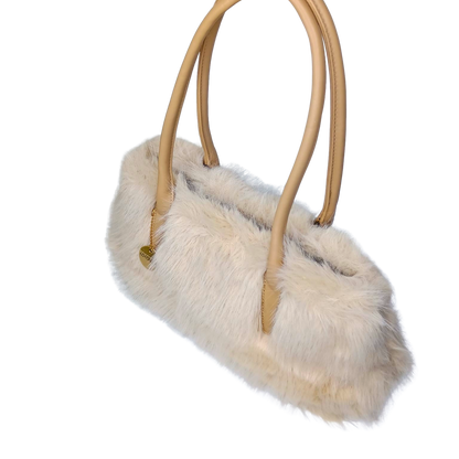 Handbag with fur detail and beige handles on a white background