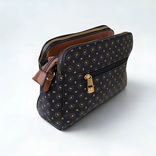 Patterned handbag with gold accents on a white background