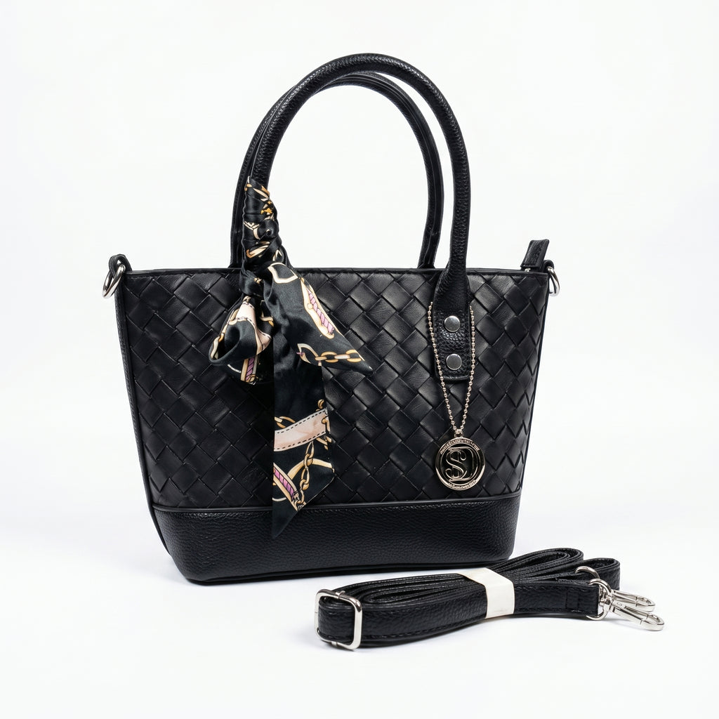 Black woven handbag with a matching scarf and detachable strap on a white background