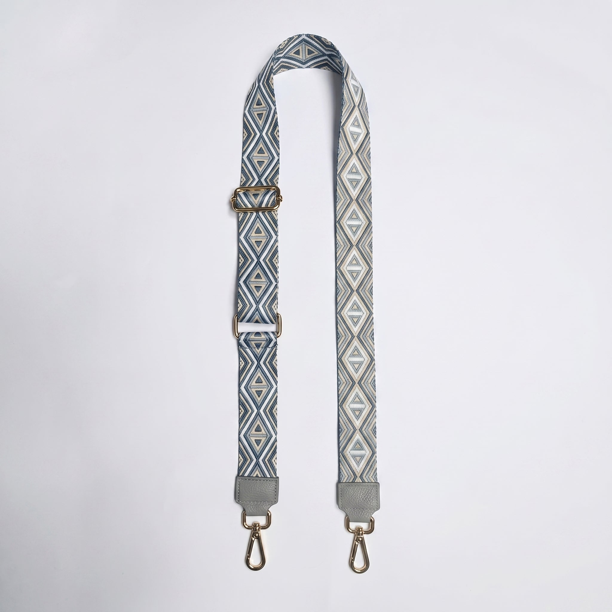 Patterned strap with metal clasps on a white background