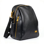 Black leather backpack with gold zippers on a white background