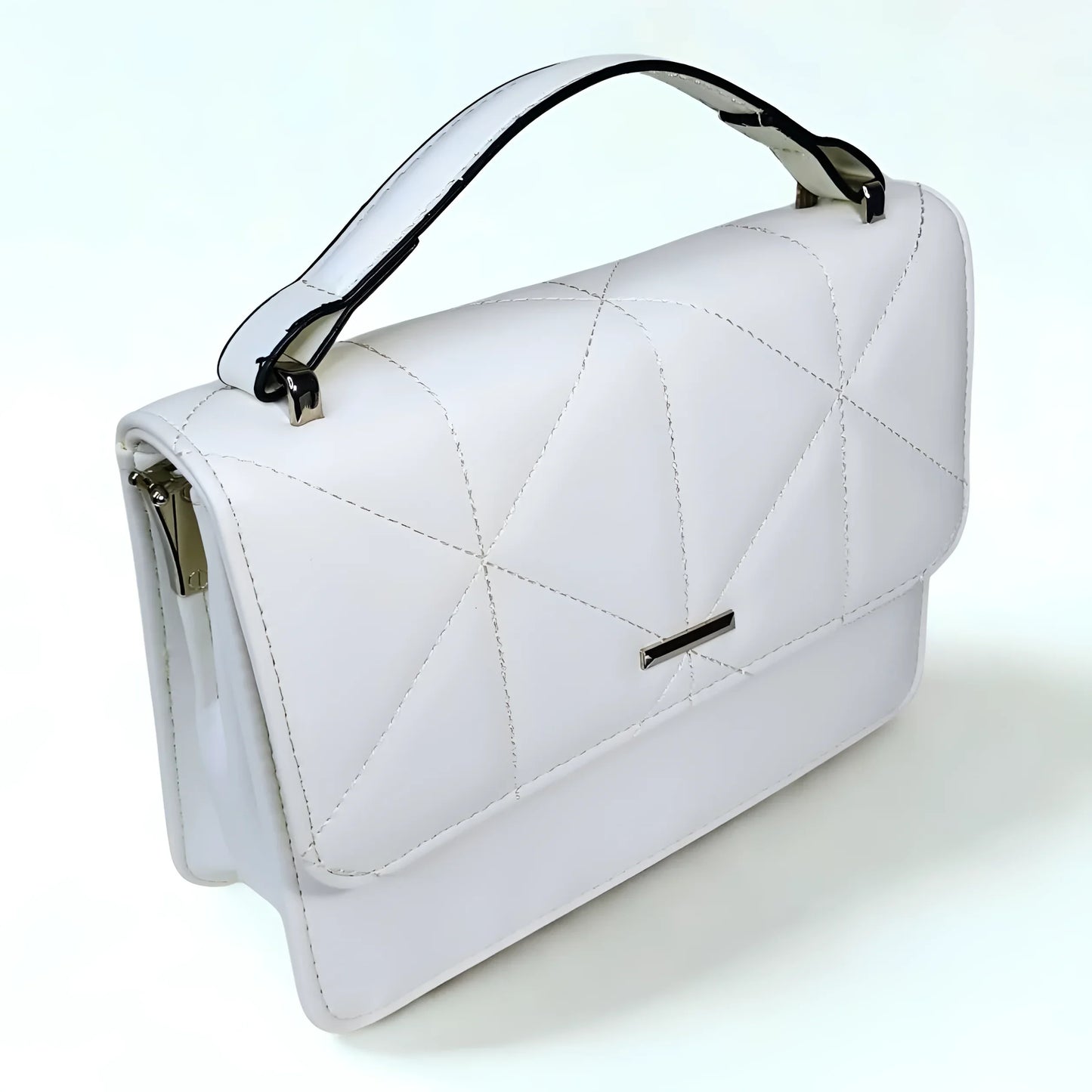 White quilted handbag with black accents on a white background