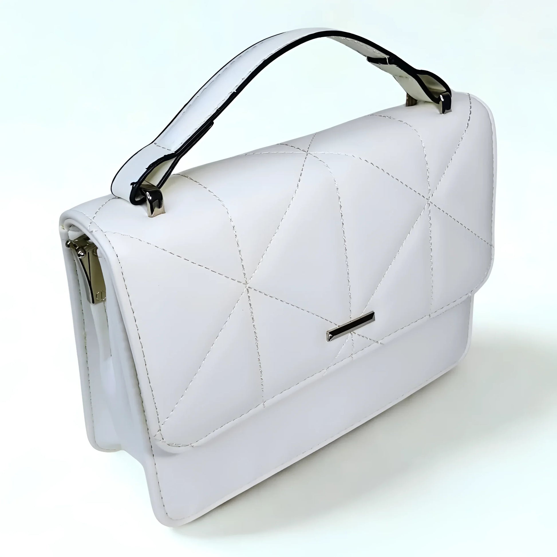 White quilted handbag with black accents on a white background