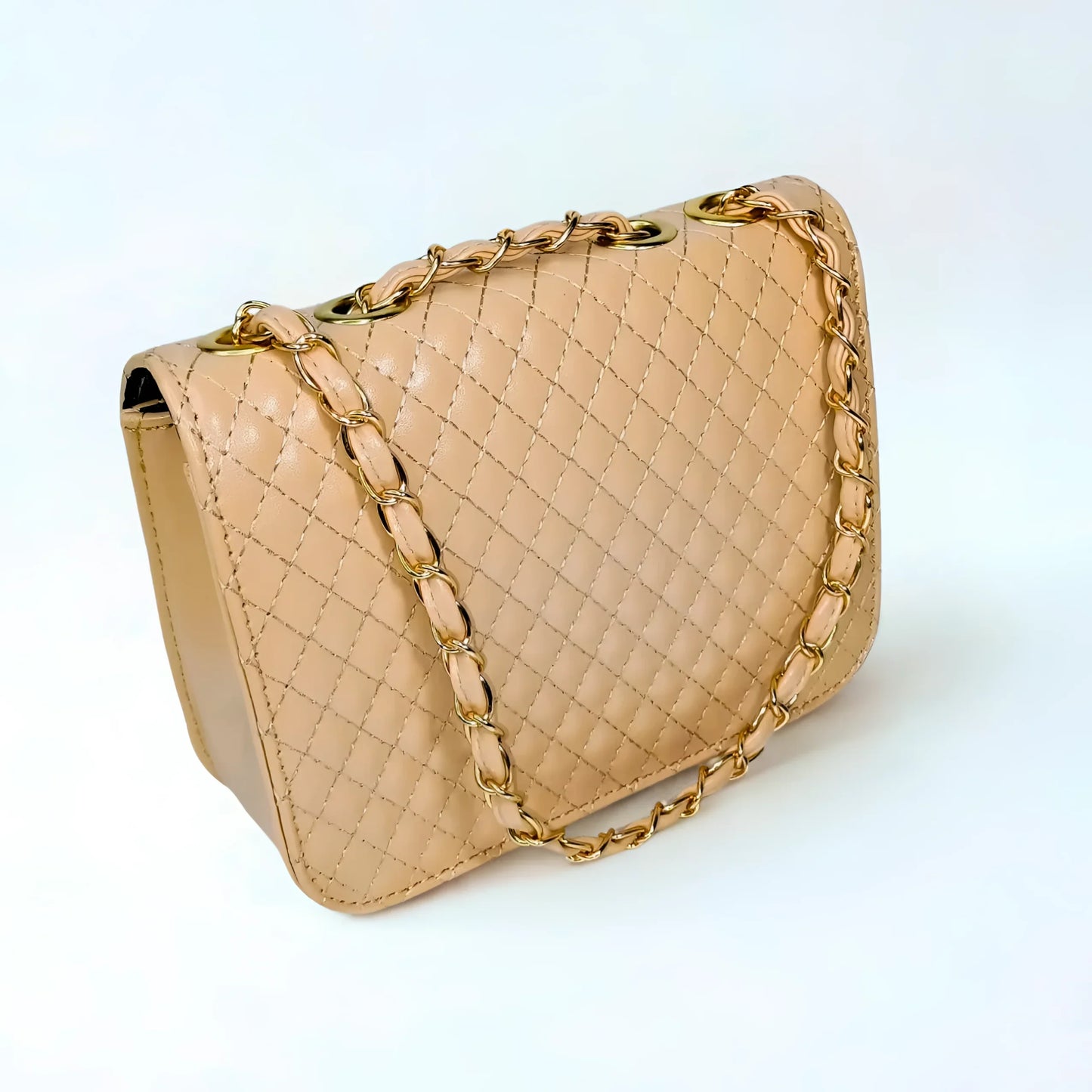 Beige quilted handbag with gold chain strap on a white background