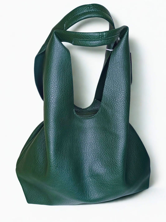 Green leather handbag on a white background