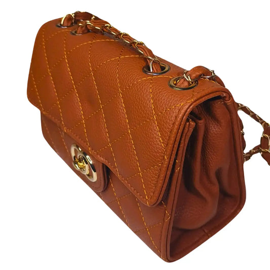 Brown leather handbag with gold chain strap on a white background