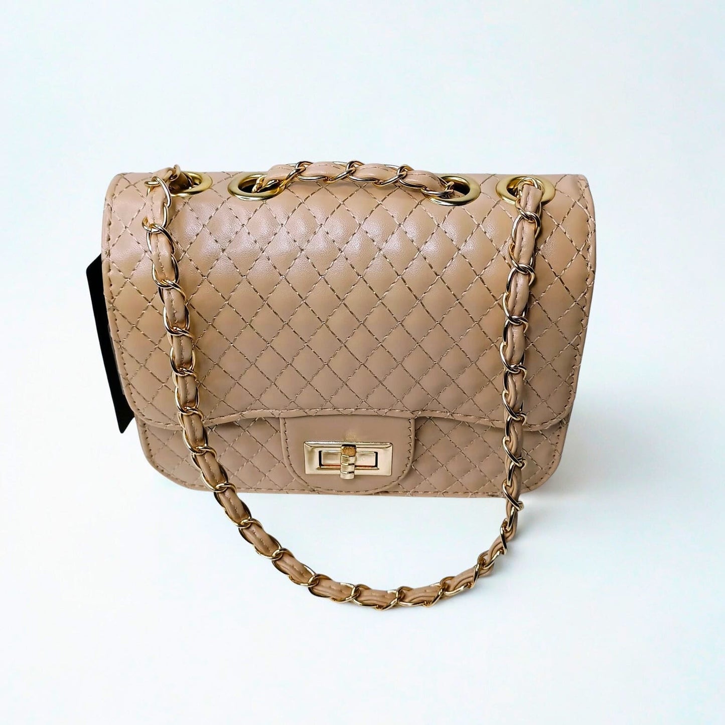 Beige quilted handbag with gold chain strap on a white background