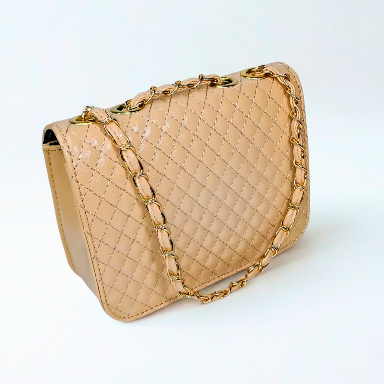 Beige quilted handbag with gold chain strap on a white background