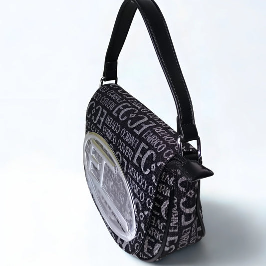 Black patterned handbag with a clear circular window on a light gray background