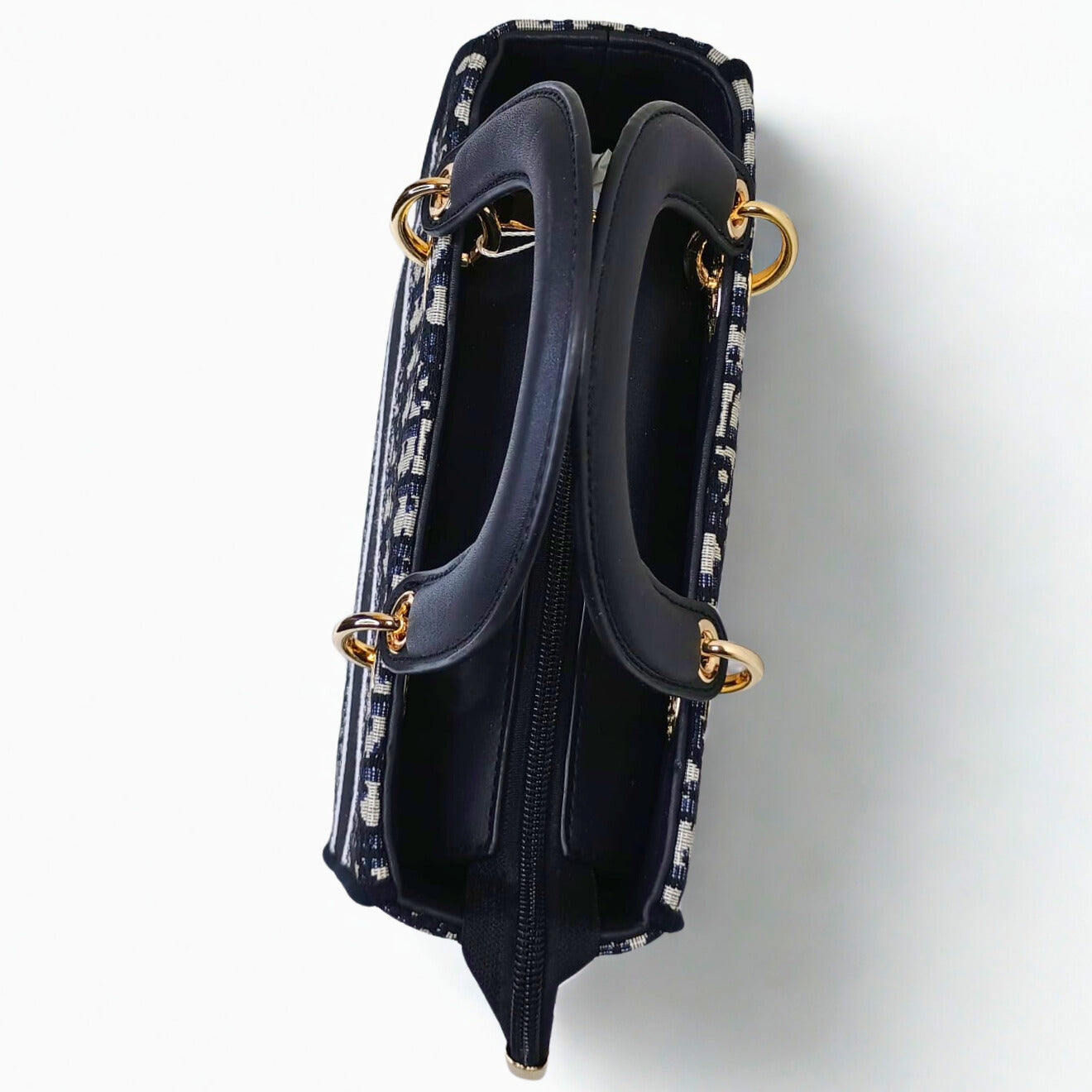 Navy handbag with gold accents on a white background