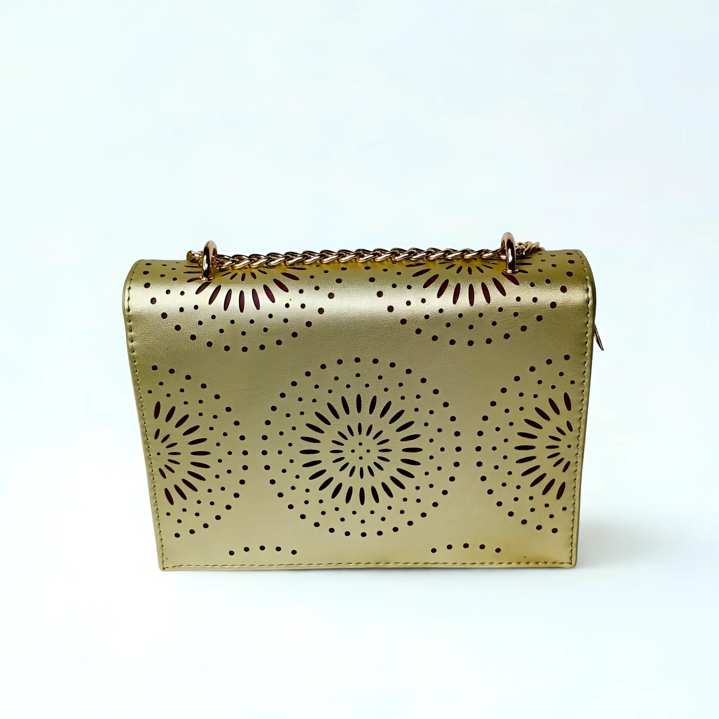 Gold handbag with sunburst patterns on a white background