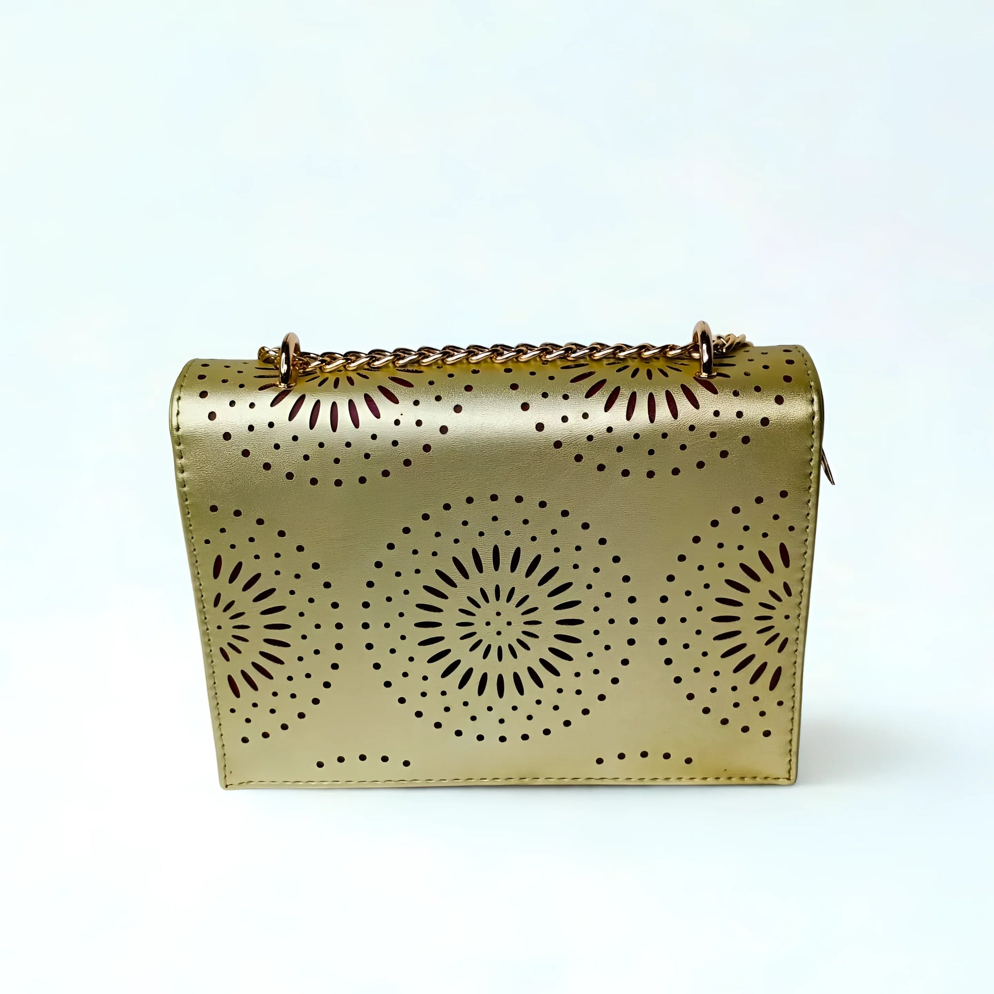 Gold handbag with sunburst patterns on a white background