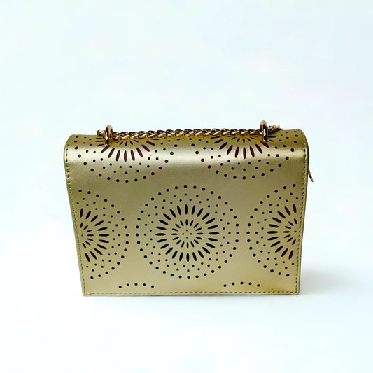 Gold handbag with sunburst patterns on a white background