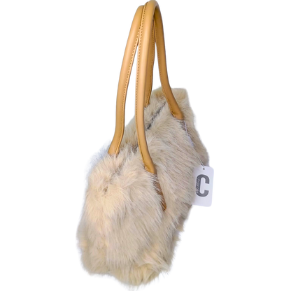 Furry handbag with beige handle on a white background