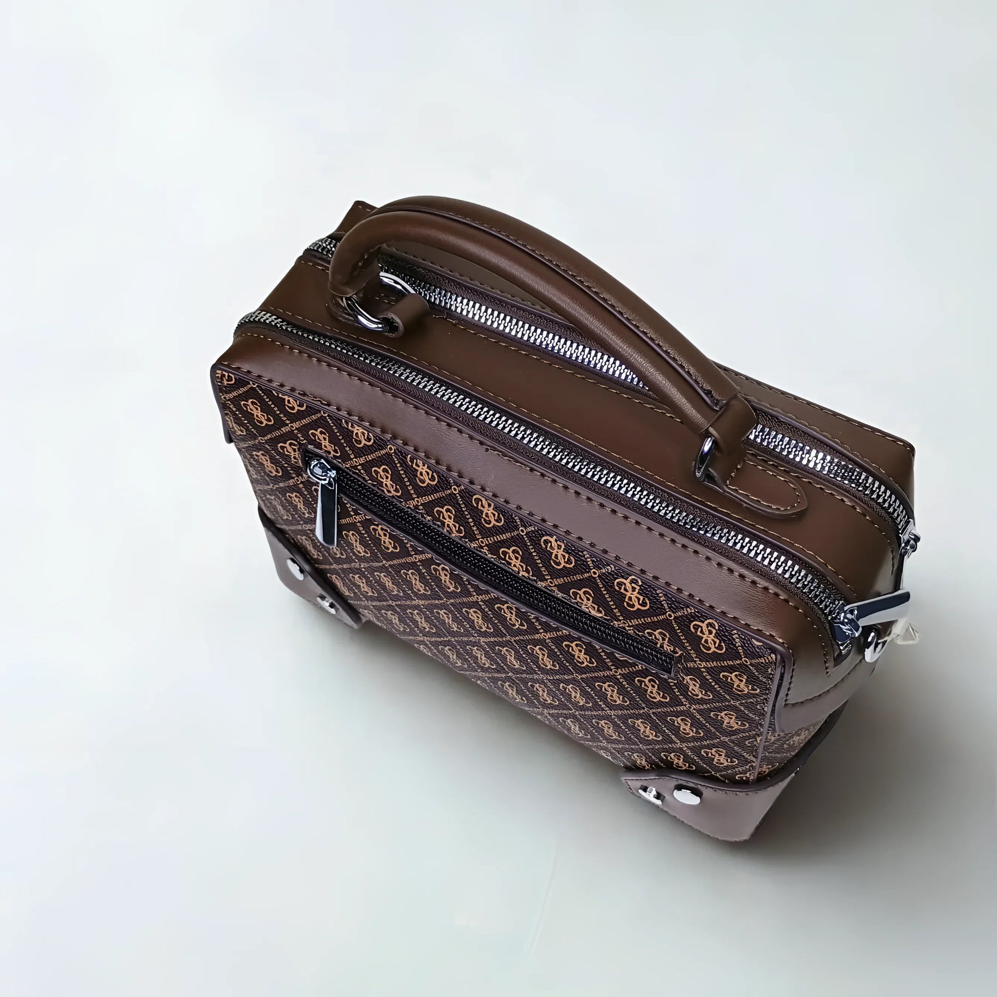 Brown patterned suitcase with zippers on a white background