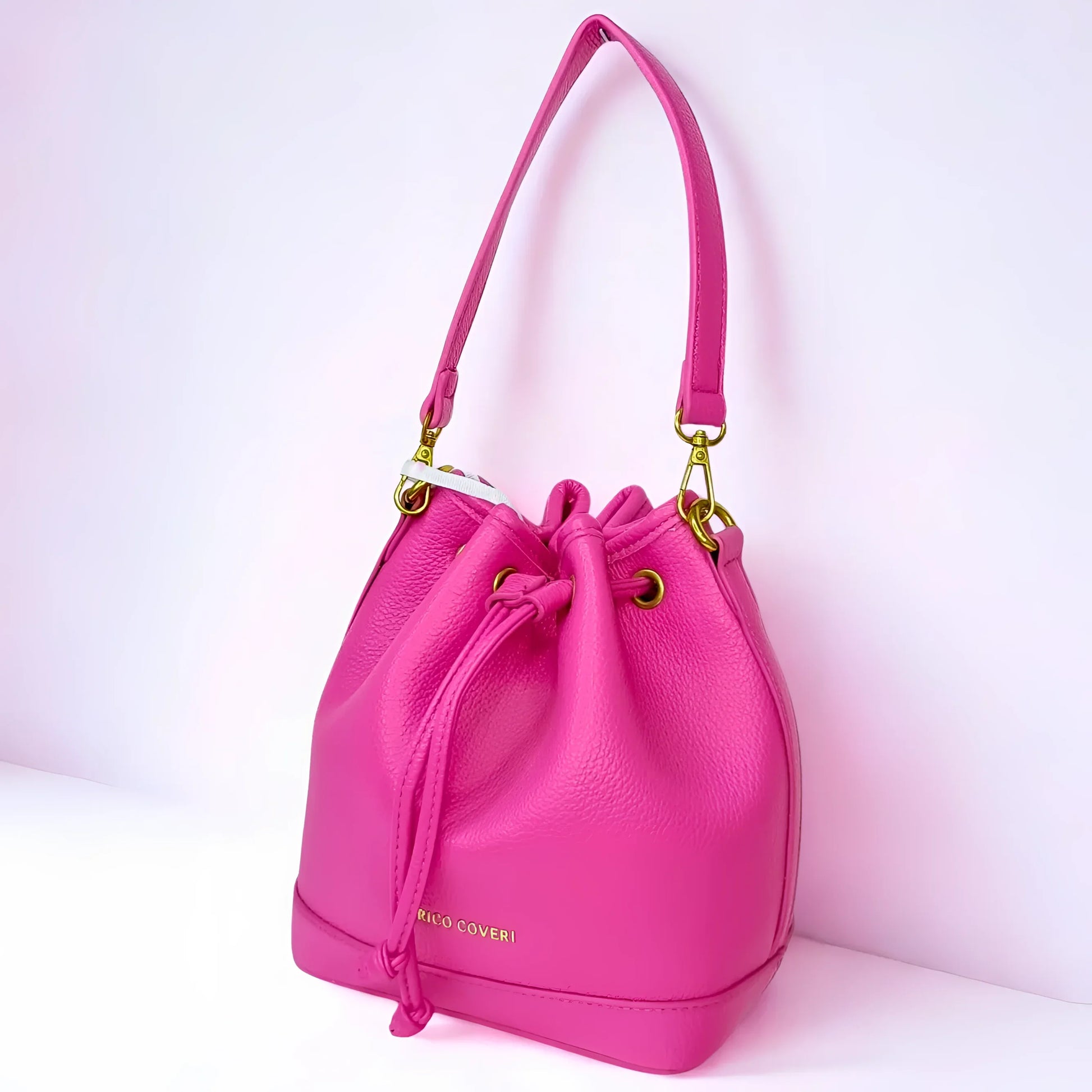 Pink handbag with gold accents on a white background