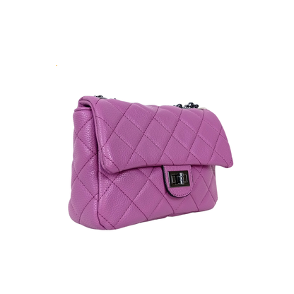 Purple quilted handbag on a white background