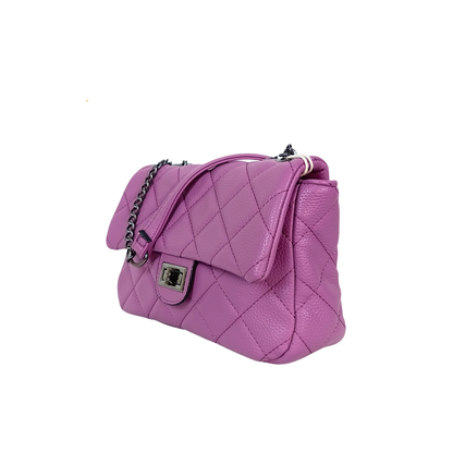 Purple quilted handbag on a white background