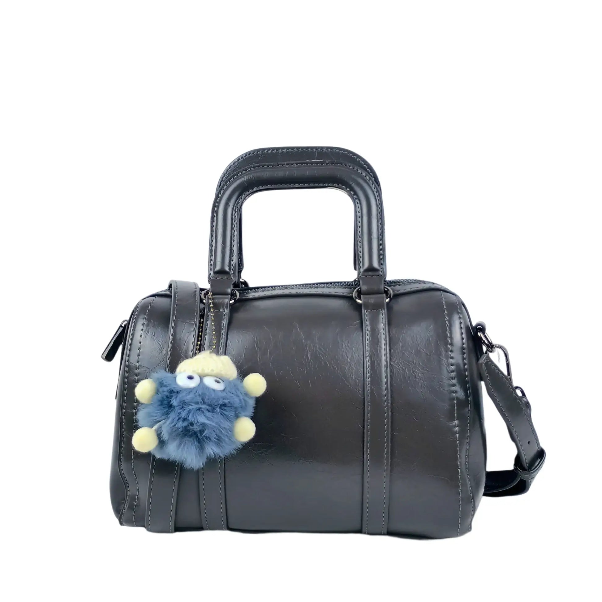 Dark gray ladies designer handbag with removable shoulder strap and fuzzy blue pom-pom charm
