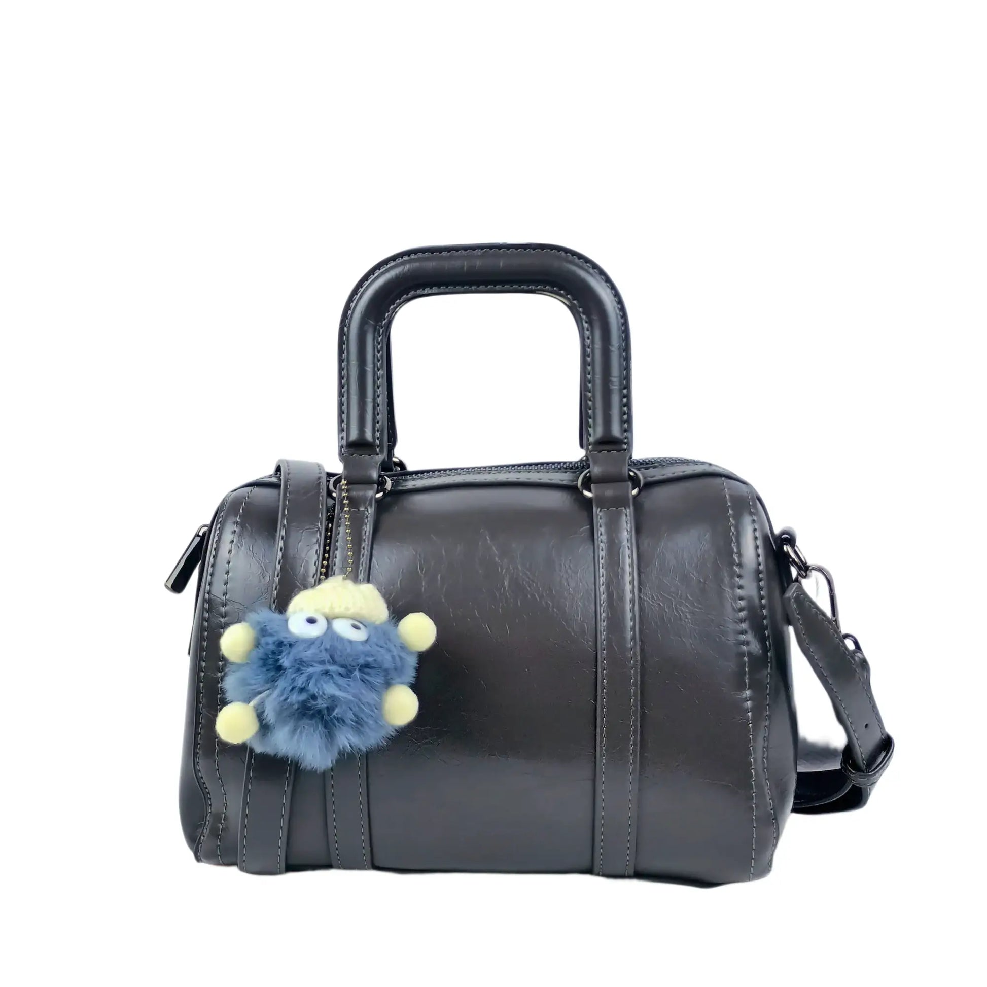 Ladies designer handbag in dark gray faux leather with removable shoulder strap and blue furry monster keychain