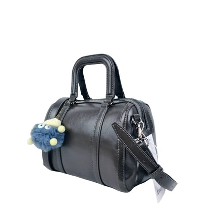 Dark gray ladies designer handbag with removable shoulder strap and fluffy blue charm