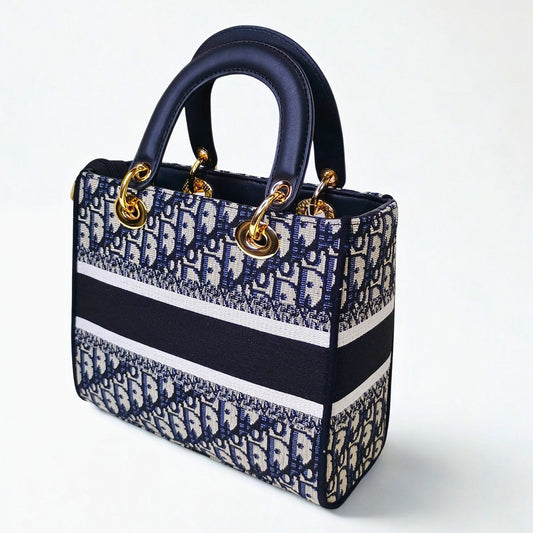 Designer handbag with blue and white pattern on a white background