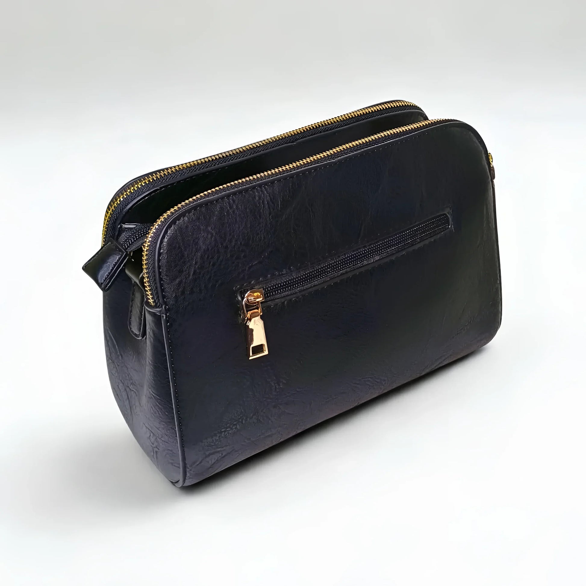 Black leather handbag with gold zipper on a white background