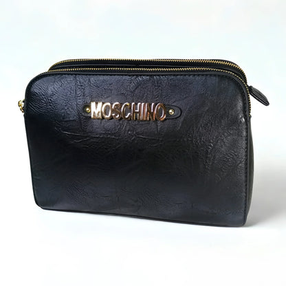 Black leather pouch with gold zipper and Moschino logo on a white background