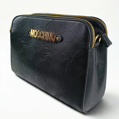 Black leather handbag with gold zipper and Moschino logo on a white background