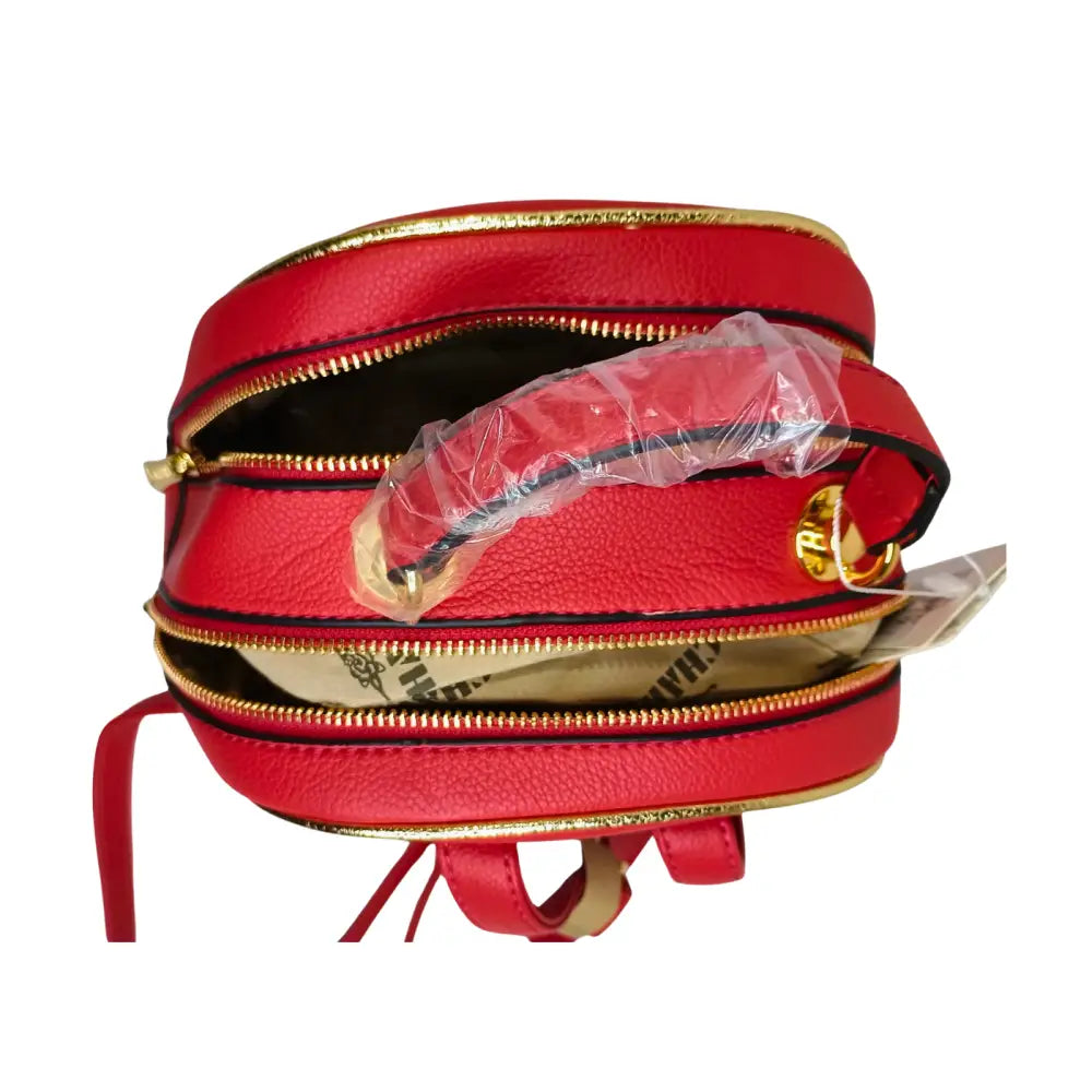 Red leather bag with gold zipper and strap on a white background