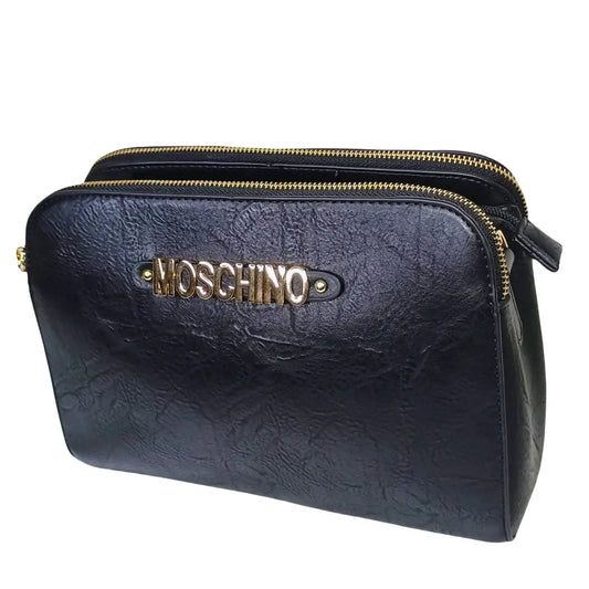 Black leather clutch bag with gold zipper and Moschino logo on a white background